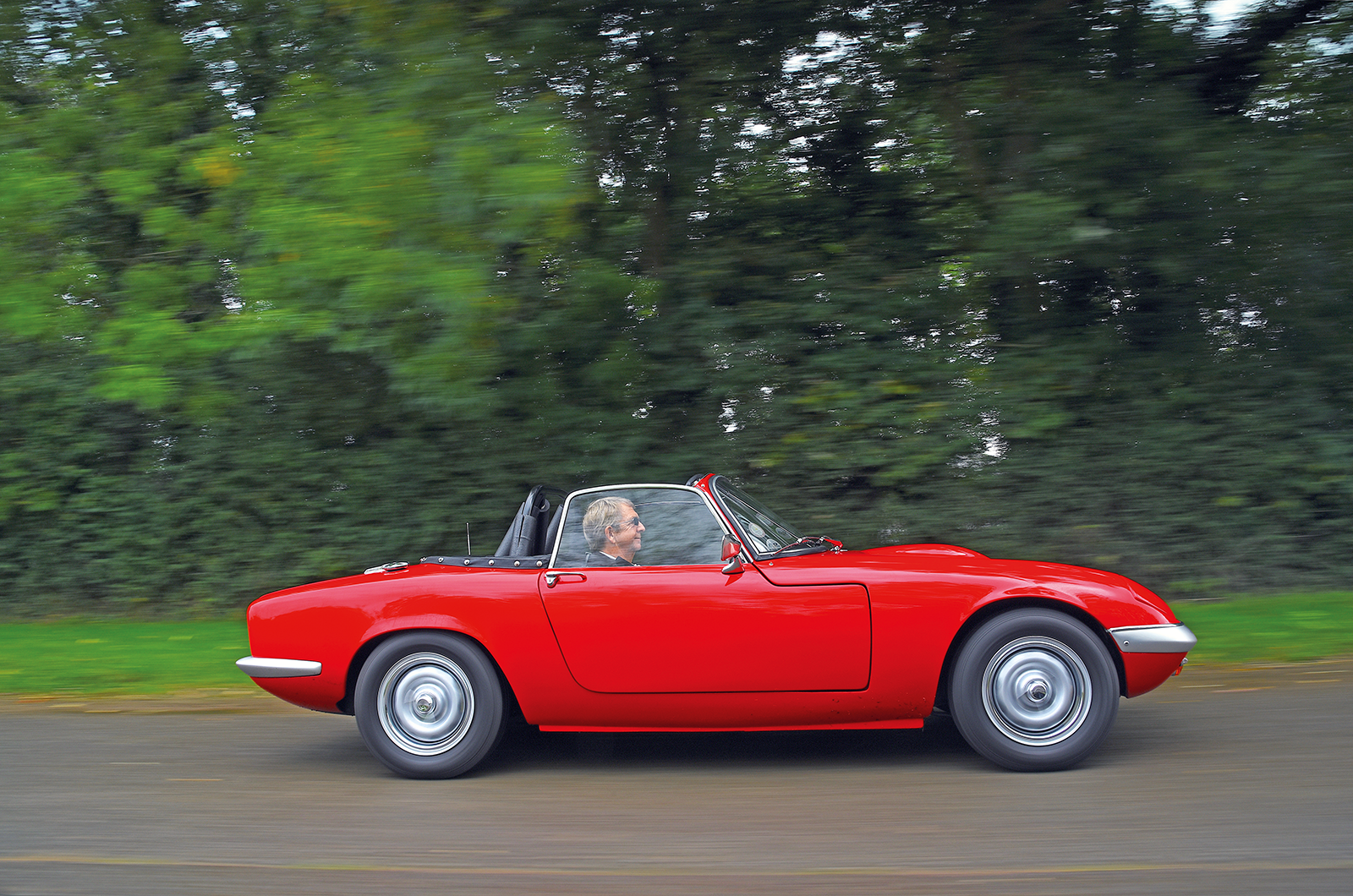Behind the wheel of this red Lotus Elan